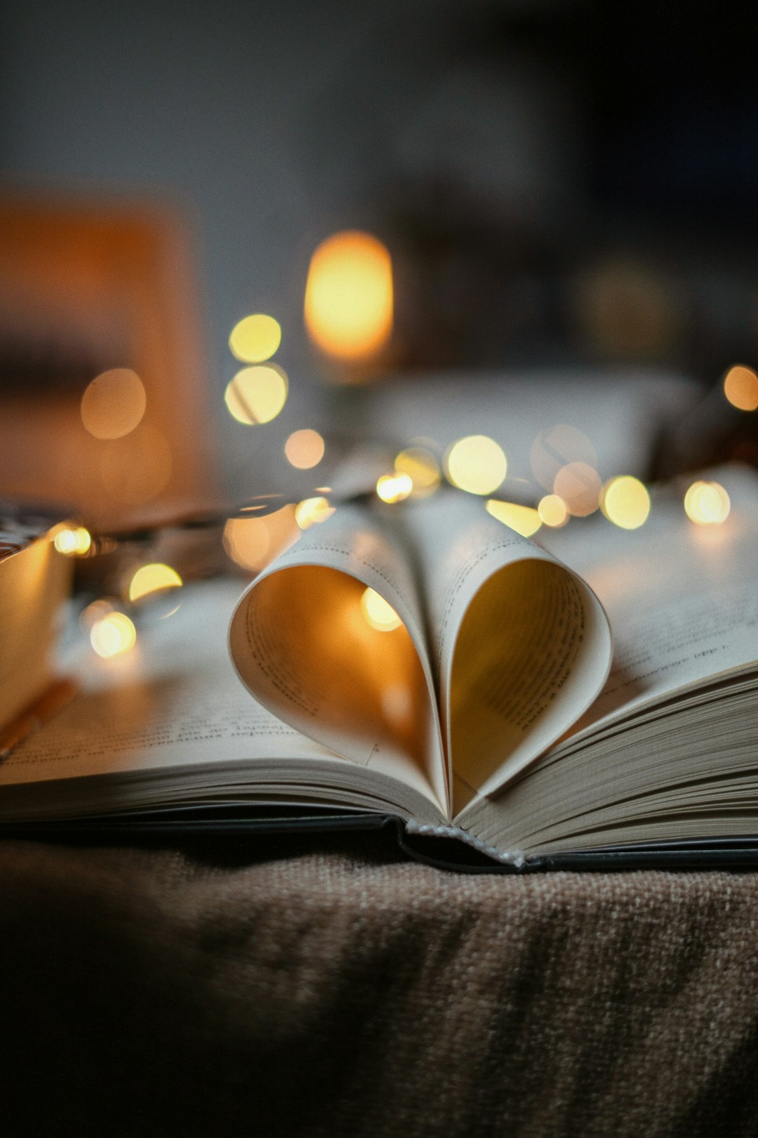 an open book with lights in the background